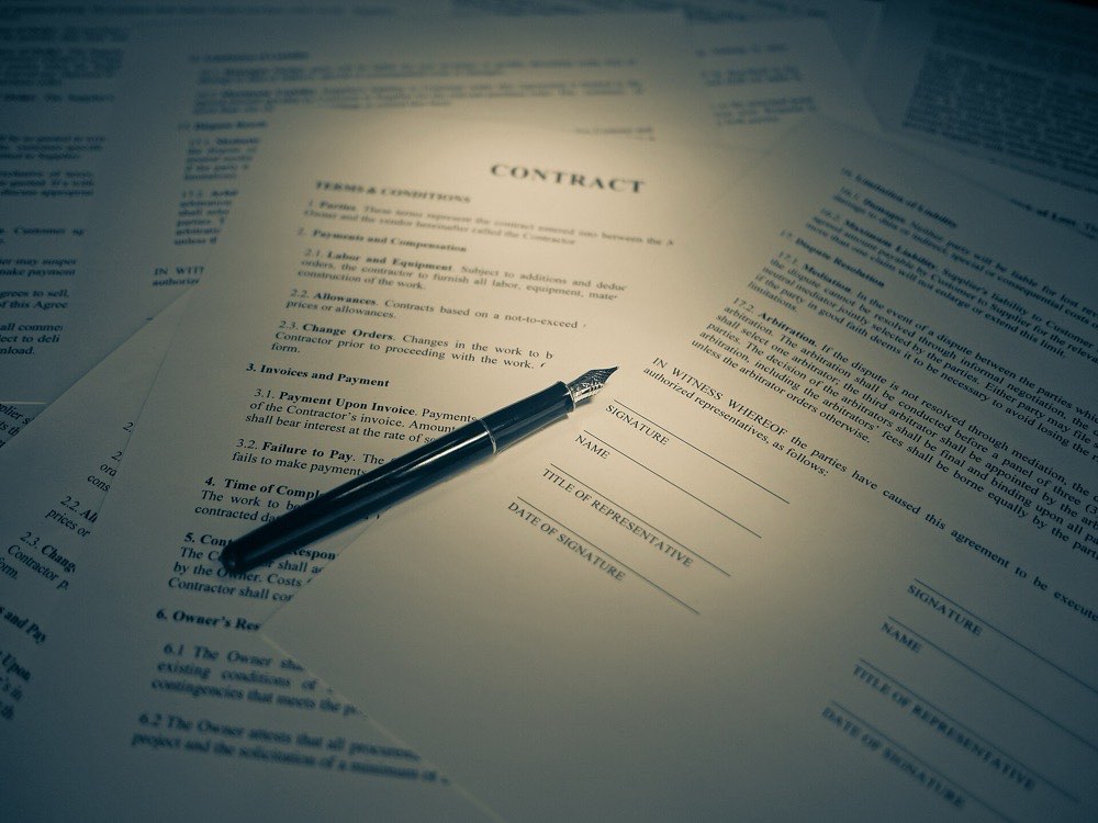 A contract and a fountain pen on a desk