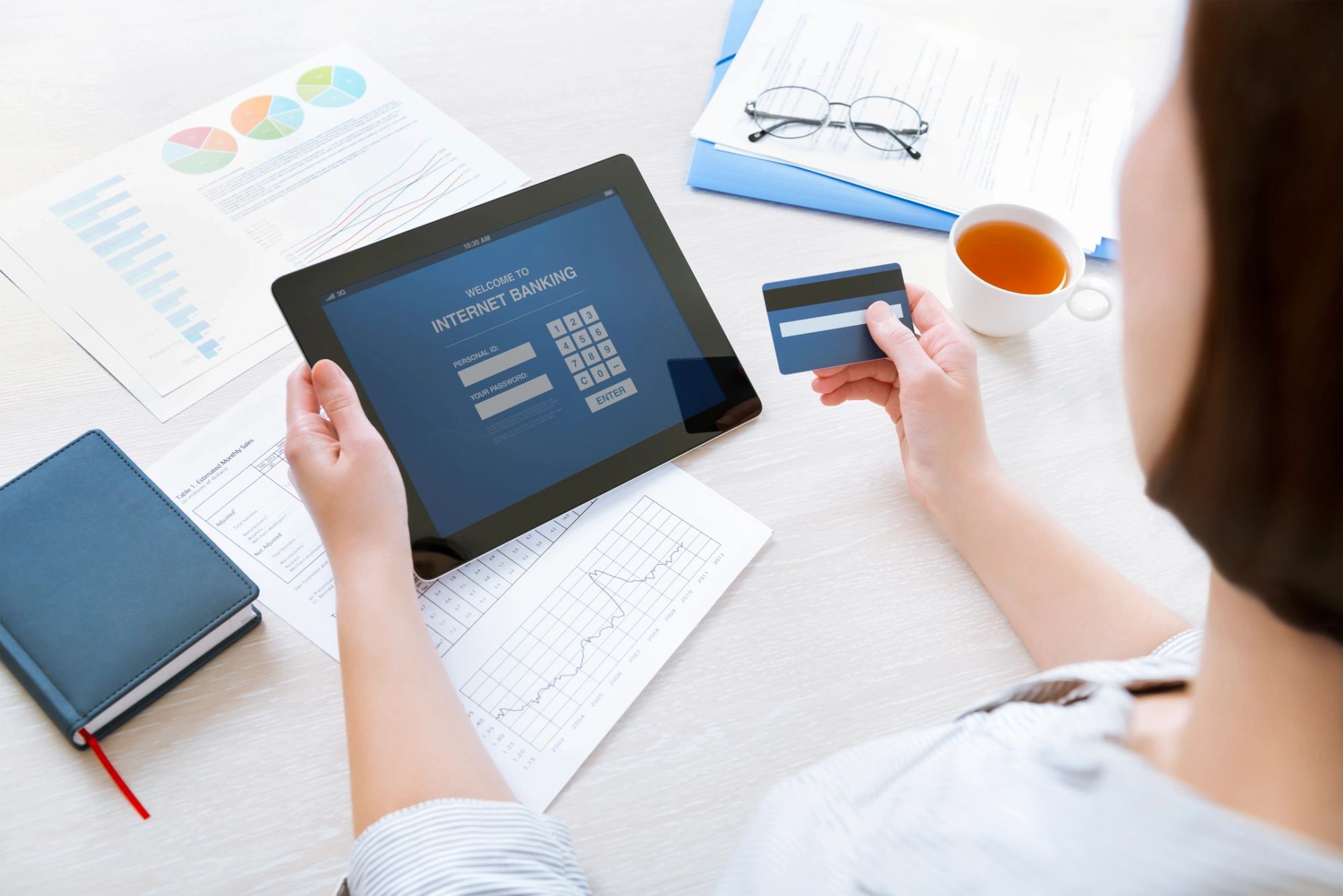 Person paying bills on a tablet