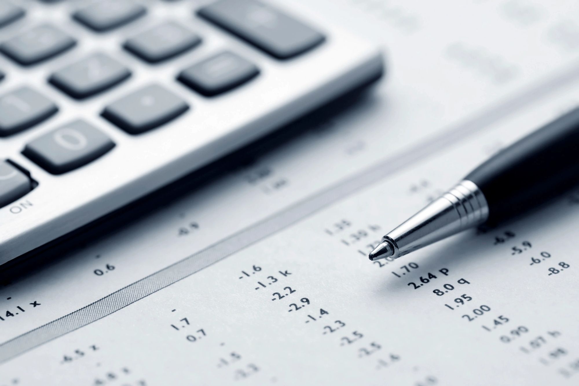 Calculator and pen on a ledger