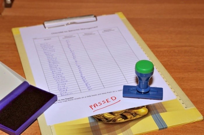 A rubber stamp and ink pad on a desk