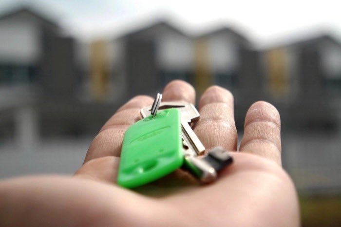 A set of house keys in an open hand