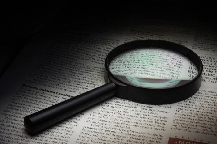 A magnifying glass over printed text