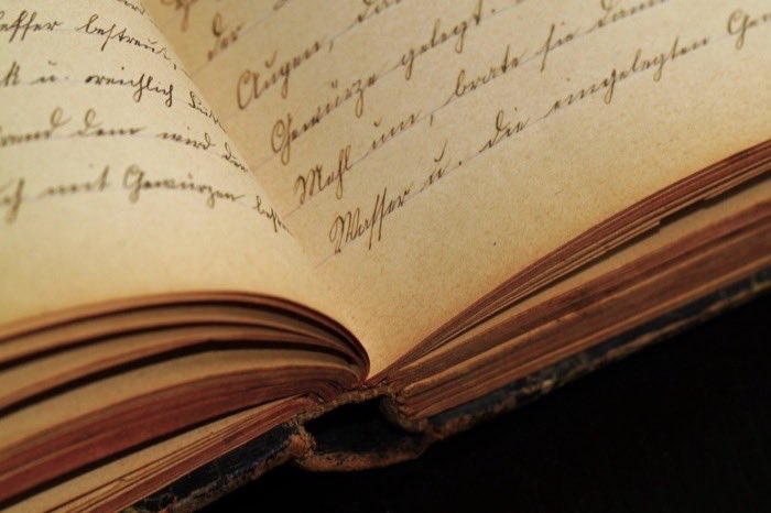 A handwritten register open on a table
